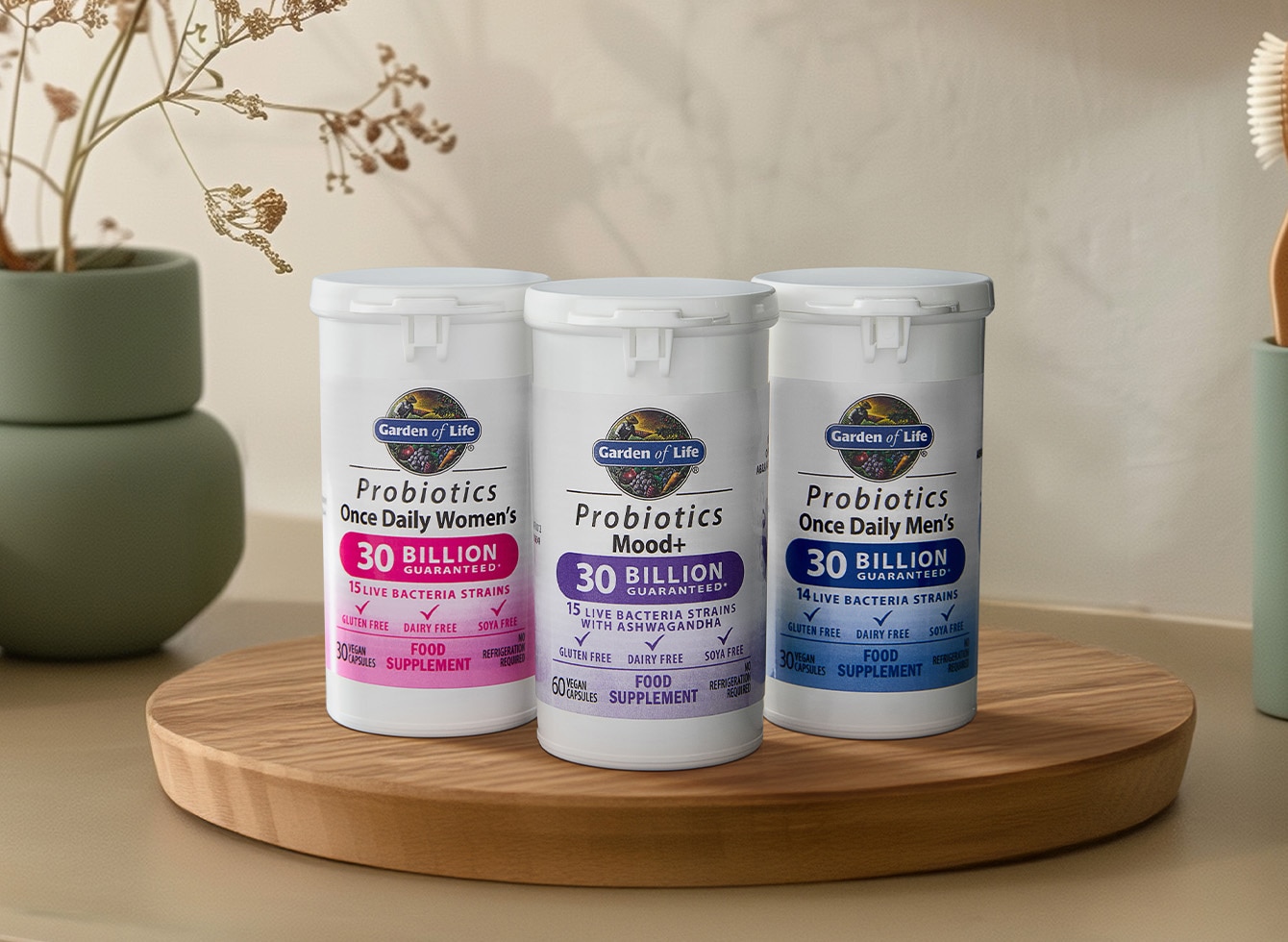 Three Garden of Life Probiotic products neatly arranged on a round display atop a countertop, showcasing premium gut health and wellness solutions.