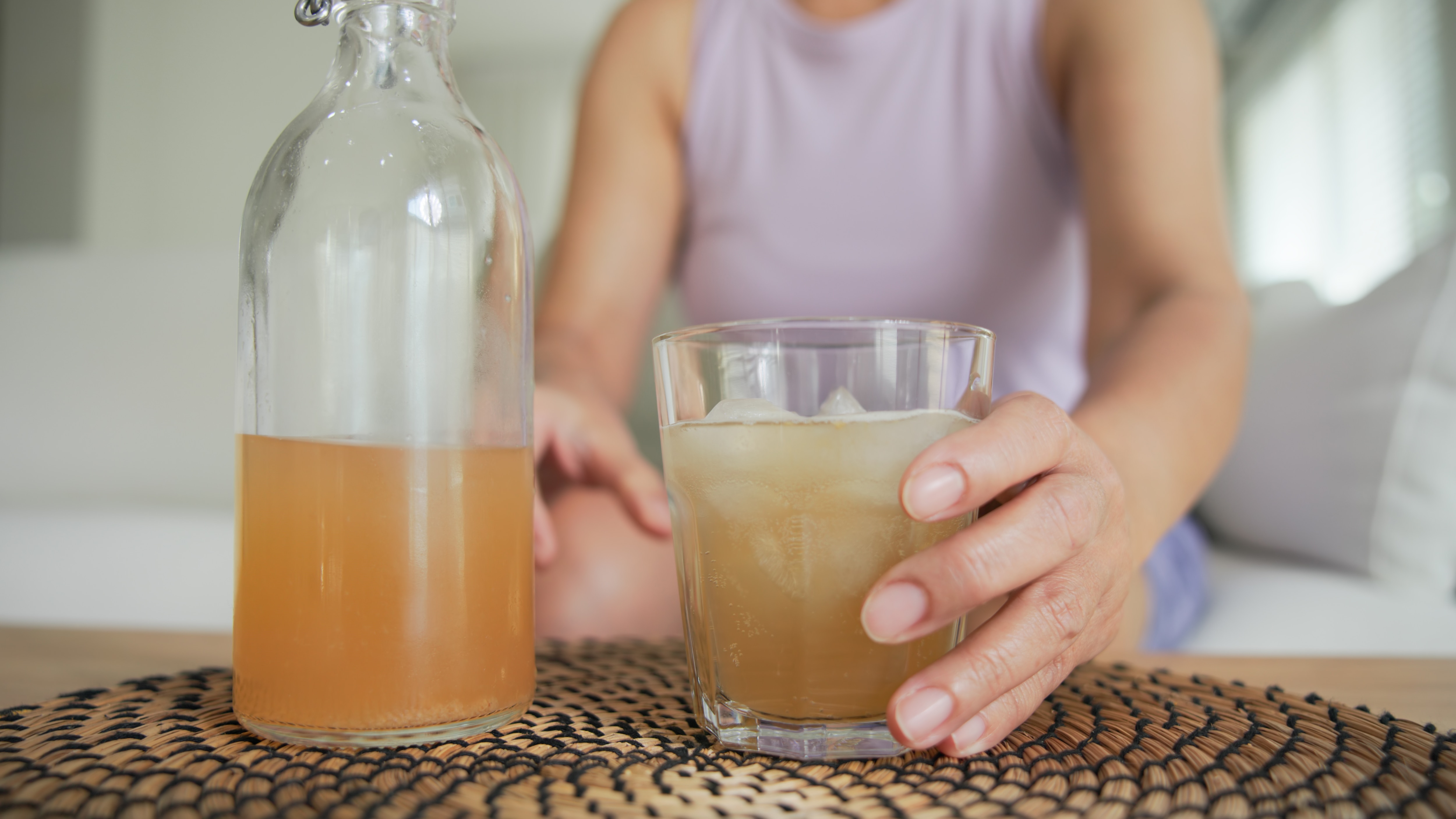 Homemade water kefir in a glass bottle with bubbles forming on the surface. Naturally fermented fizzy probiotic drink made from kefir grains, offering a refreshing, gut-friendly alternative to soda.